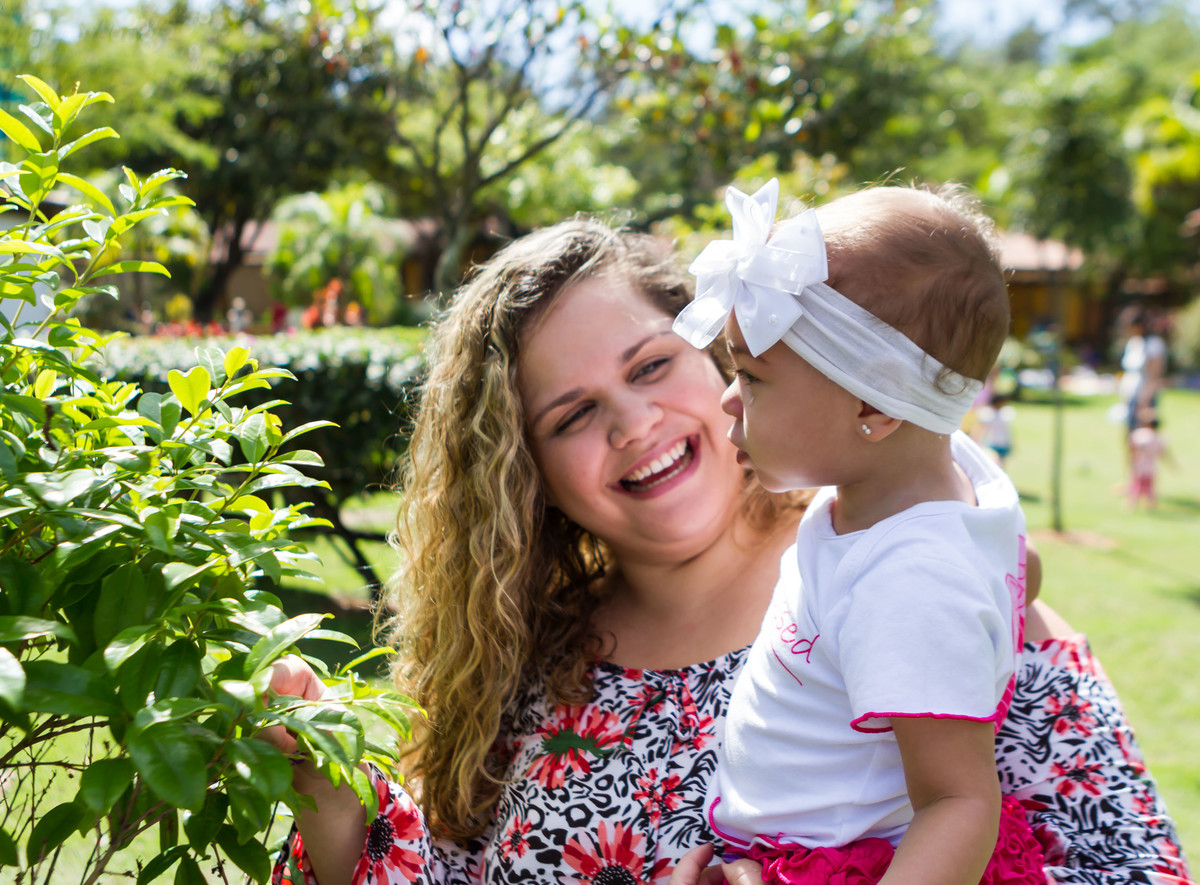 Luísa olhando para as flores pelo fotógrafo Douglas Maia