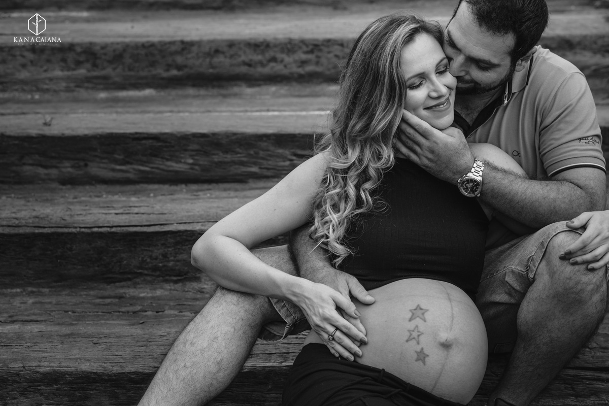 marido beija sua mulher grávida e faz carinho na barriga durante ensaio de fotos de gestante na cidade de lençóis paulista no interior de São Paulo sp