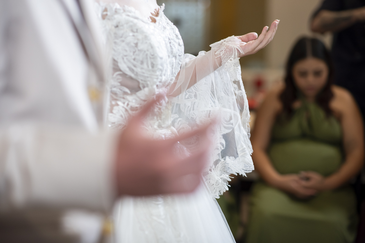 fotografo faz foto espontanea incrivel com detalhe da mao da noiva e vestido de renda e madrinha gestante em cerimonia de casamento intimista em bauru
