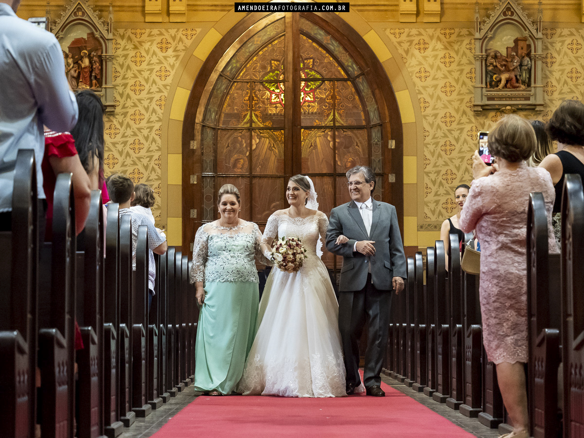 noiva entrando com o pai e a mae no seu casamento na igreja matriz de jau