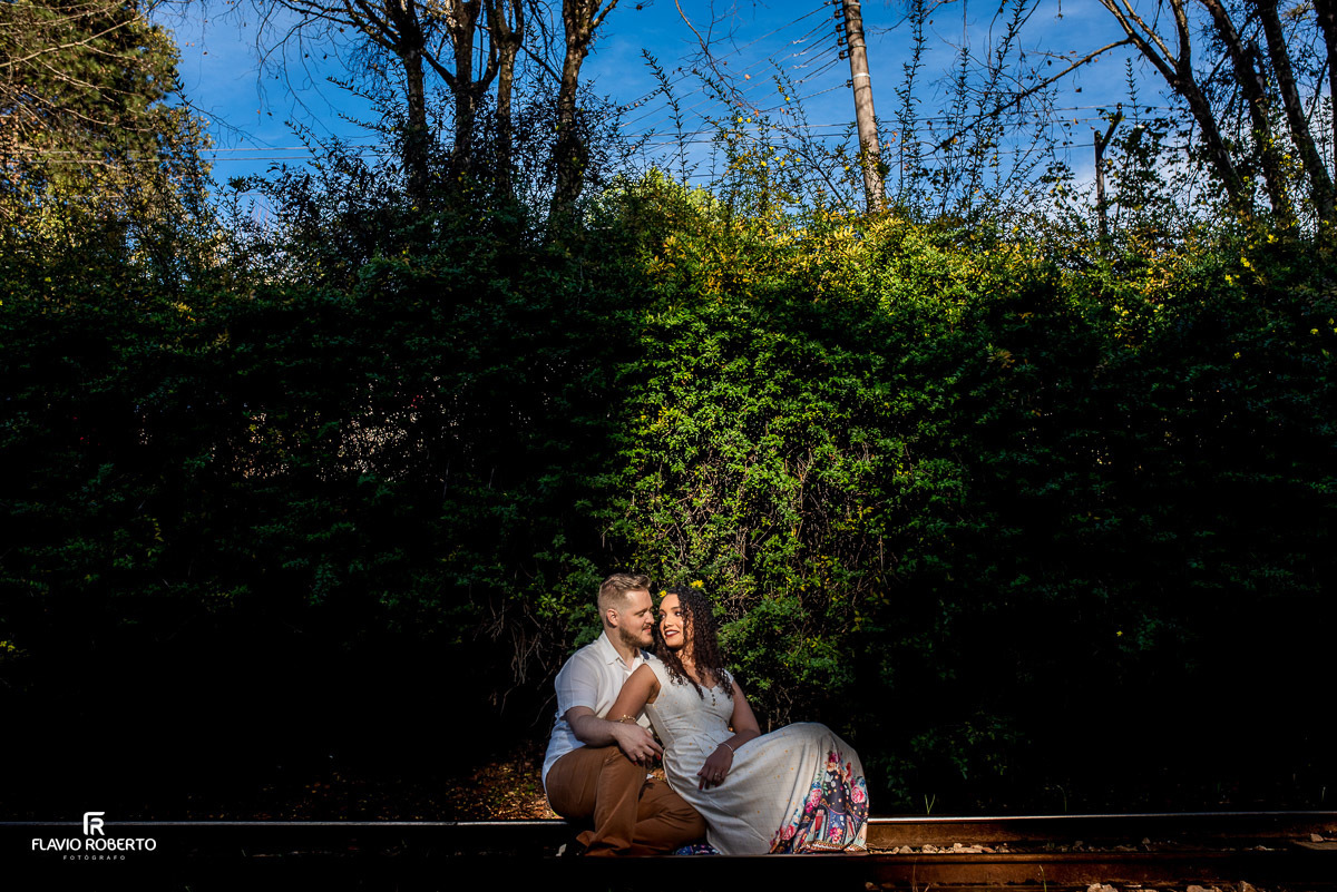 noivos sentados namorando na linha do trem durante Ensaio Pre Wedding em Campos do Jordão