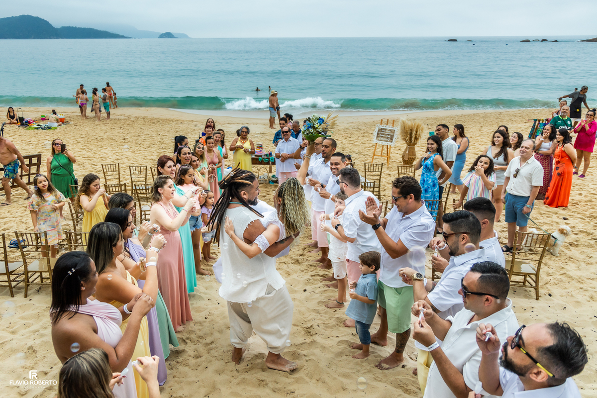 Noivos e convidados celebrando casamento pé na areia na Praia de Fora em Paraty
