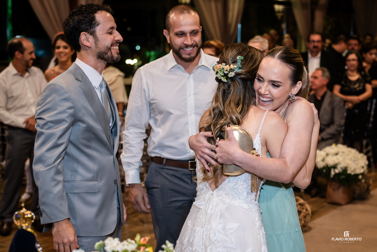Cena emocionante do casamento de Laís e Alessandro no Villa Lyon de Taubaté, abraçando seus padrinhos e familiares.