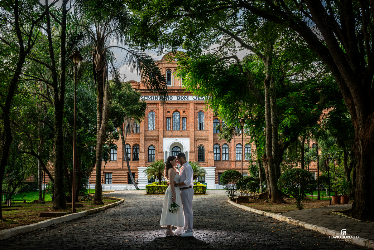 Casal em contra luz com arquitetura da Pousada Bom Jesus em Aparecida criando efeito artístico