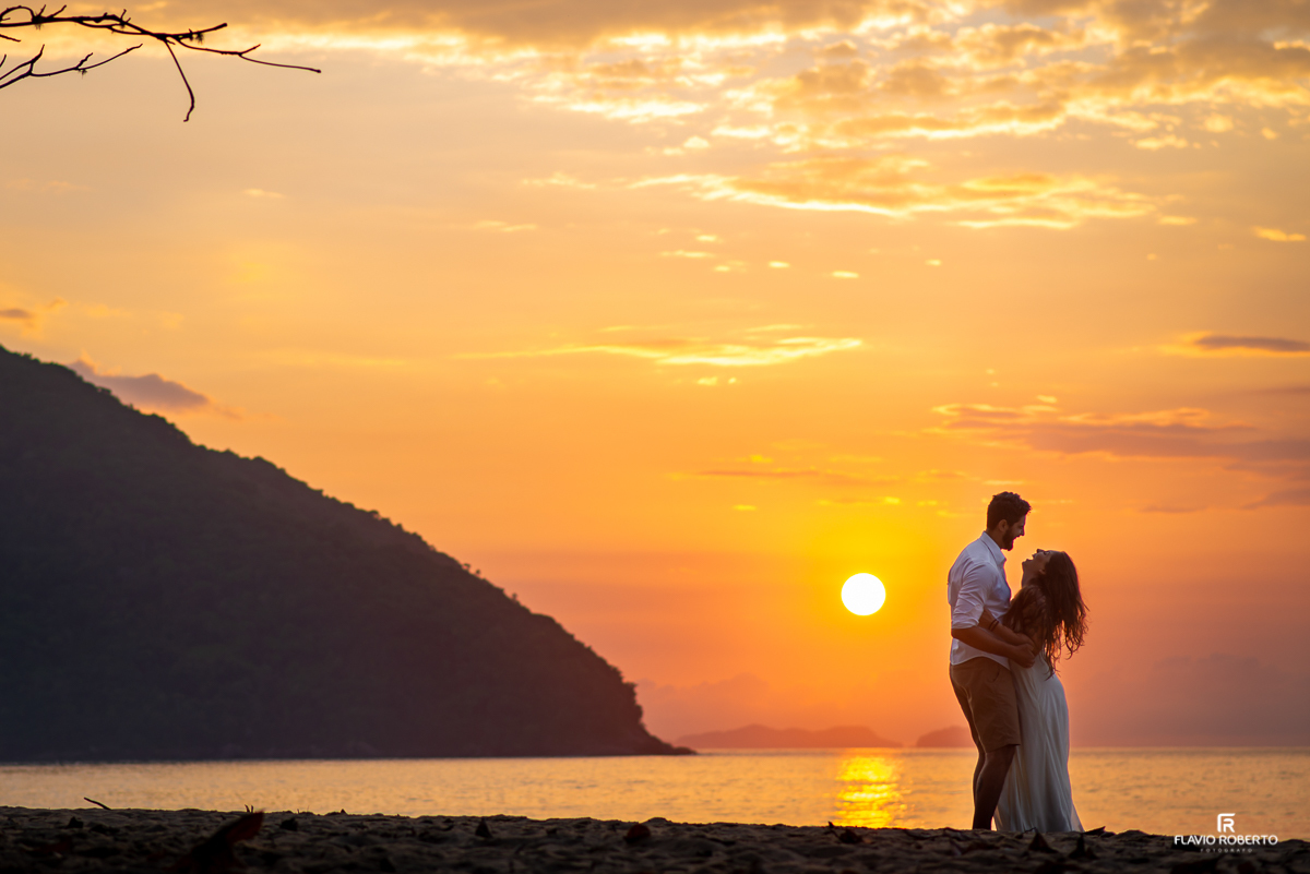 Noivos abraçados durante amanhecer na Praia Vermelha durante Ensaio Pre Wedding em Ubatuba