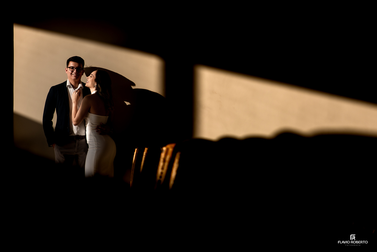 Casal abraçado encostado na parede da Capela do Recanto do Bosque em Guaratinguetá.