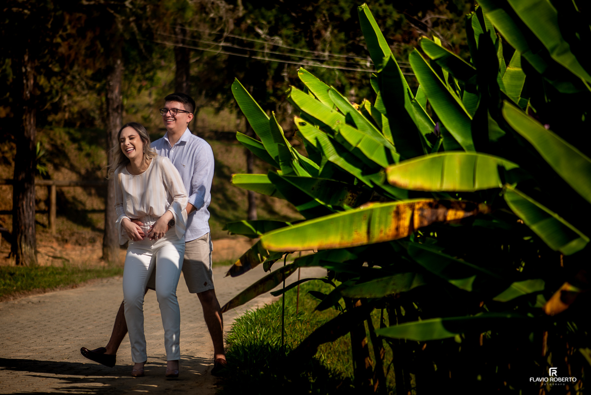 Casal caminhando dando risada do lado la lago do recanto do Bosque durante Pre Wedding em Guaratinguetá.