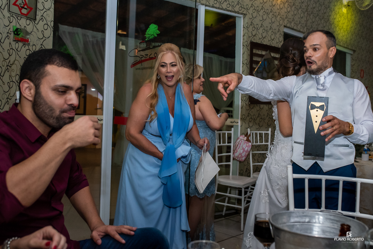 Noivos passando a gravata e o sapatinho entre os convidados durante casamento no espaço vip de Guaratingueta-sp