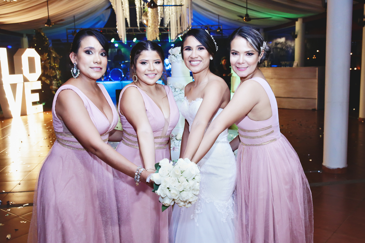 Novia y damas de honor compartiendo el ramo.