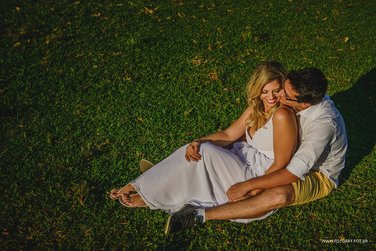 Larissa e Gustavo noivos se abrancando sentados na grama na usina indiana em Botucatu foto de Anderson Silva Fotoart fotografo sp
