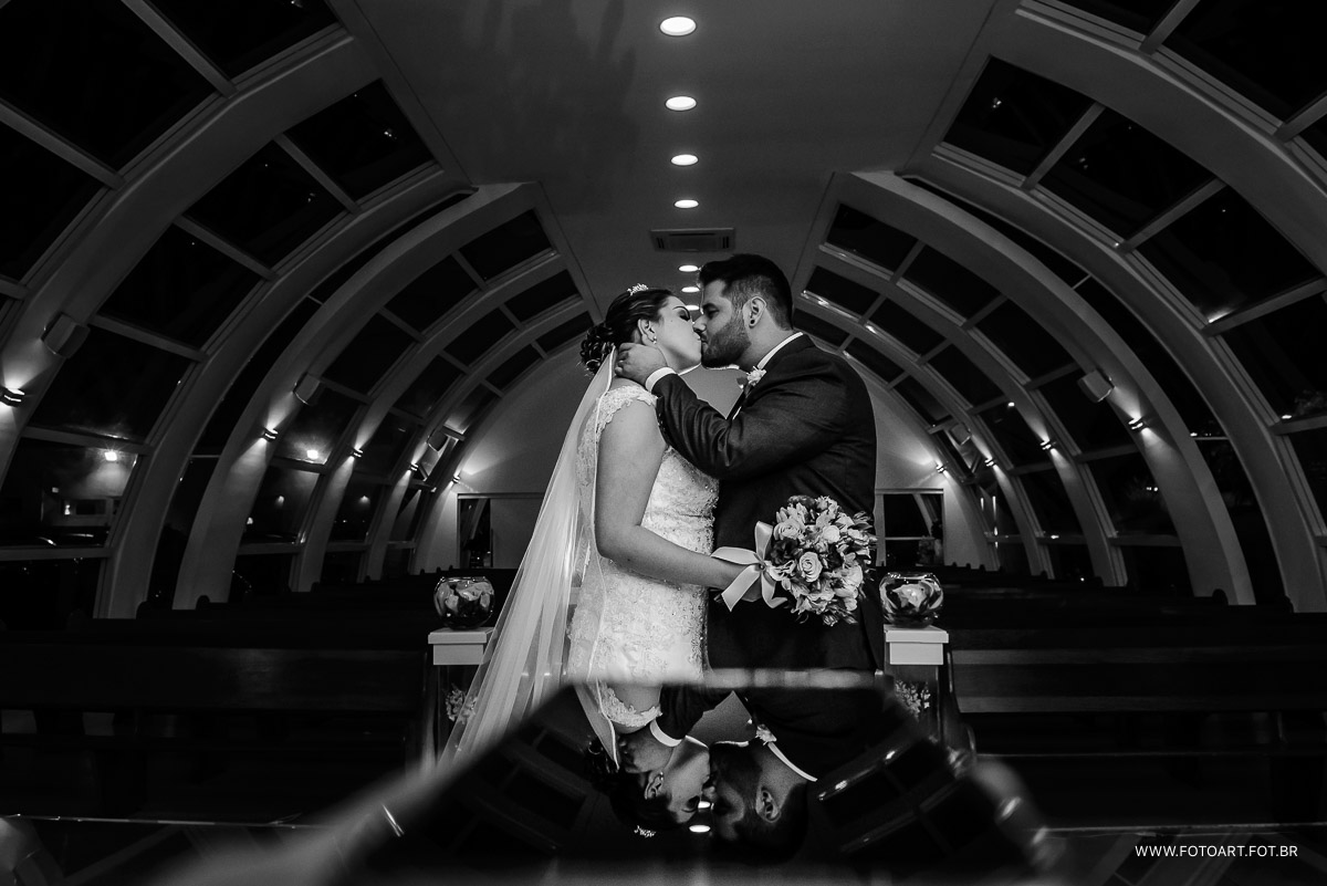 foto com reflexos e noivos se beijando na capela de vidro do luz tropical eventos foto de Anderson Silva Fotoart fotografo sp