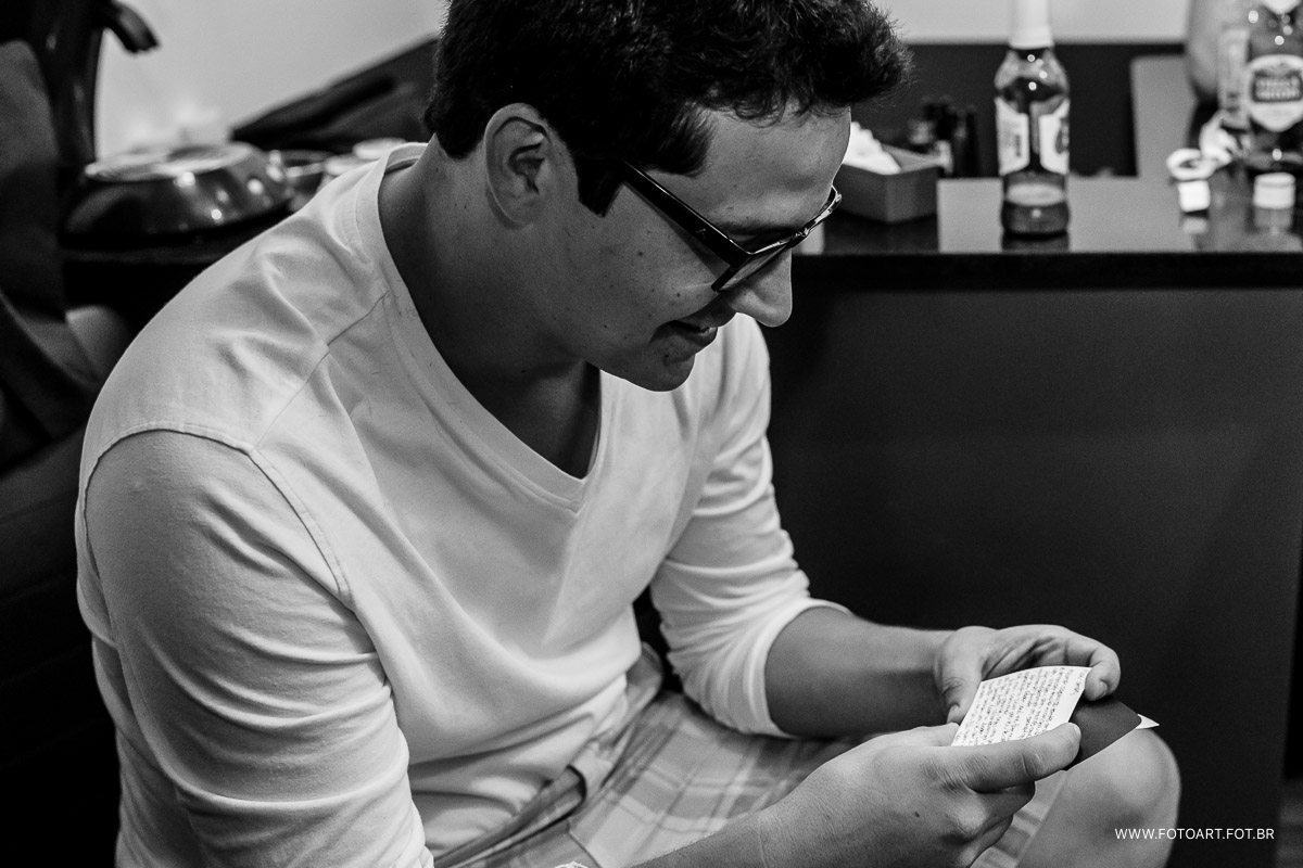 noivo lendo cartao enviado pela novia enquanto estava no making of na barbearia cabra macho foto de Anderson Silva Fotoart fotografo sp