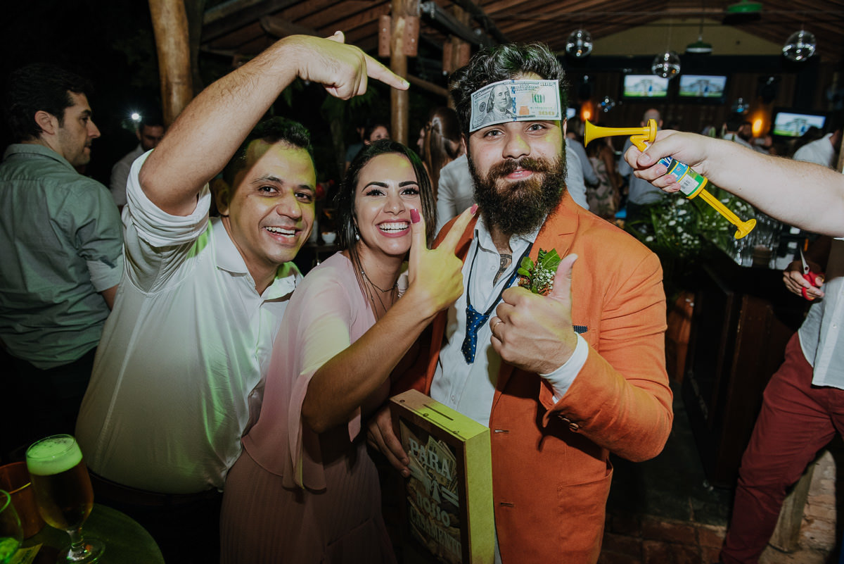 gravata do noivo recebendo dolares em casamento ao ar livre em aburu