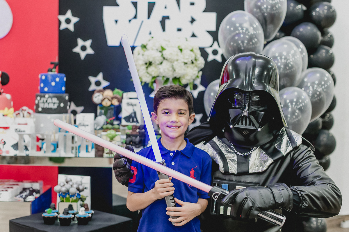 retrato com o dart vader na frente da mesa do bolo