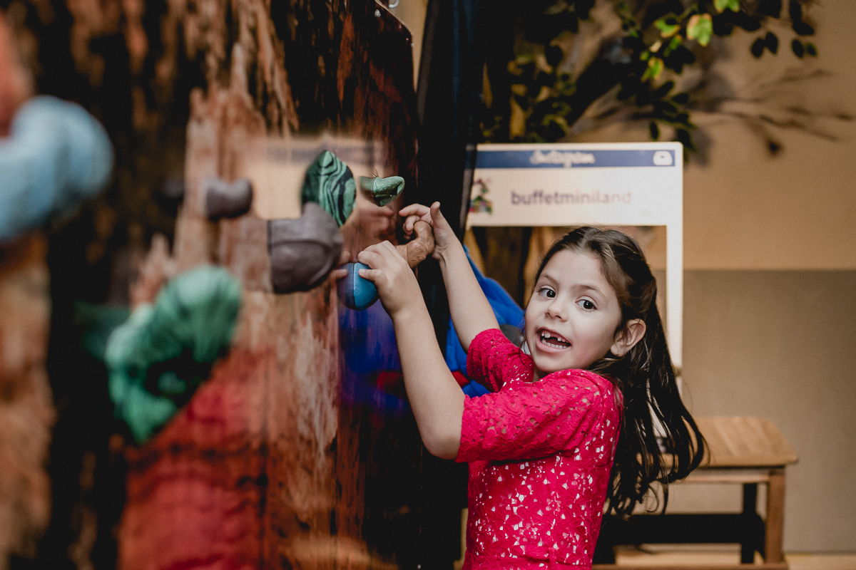 Bruna brincando de escalada no buffet miniland