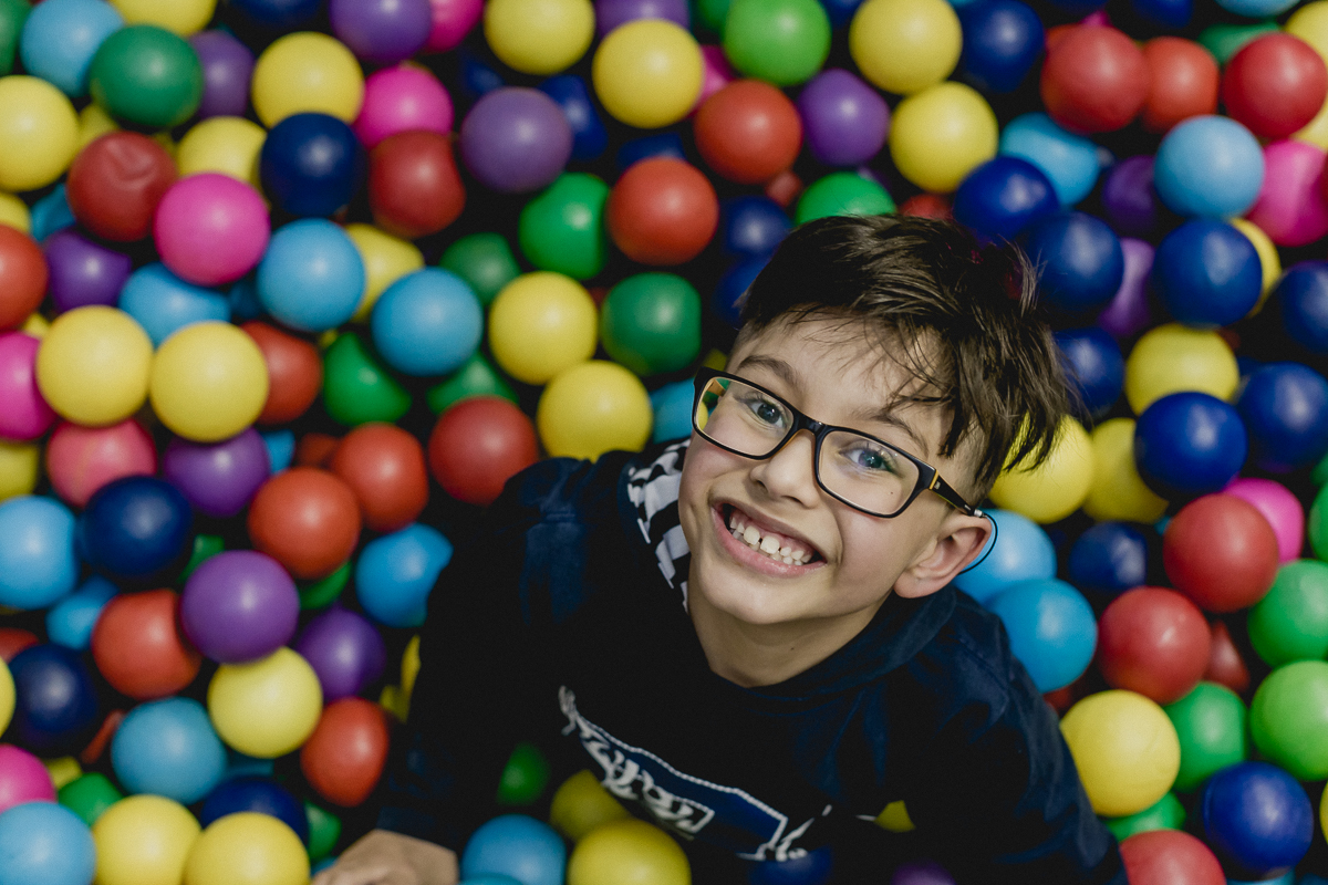 Amiguinho brincando na piscina de bolinhas