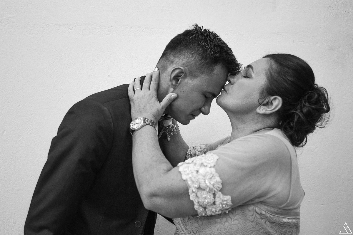 Jesscia Mendes Fotografia. Mãe do noivo dando beijo na sua testa na frente da igreja.