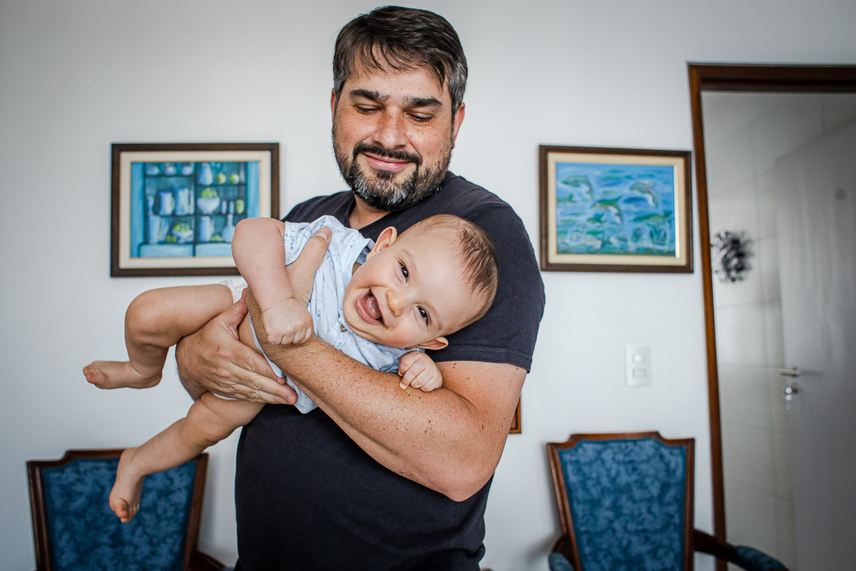psi segurando bebê de 7 meses. Fotografia documental de família em Caruaru-PE.