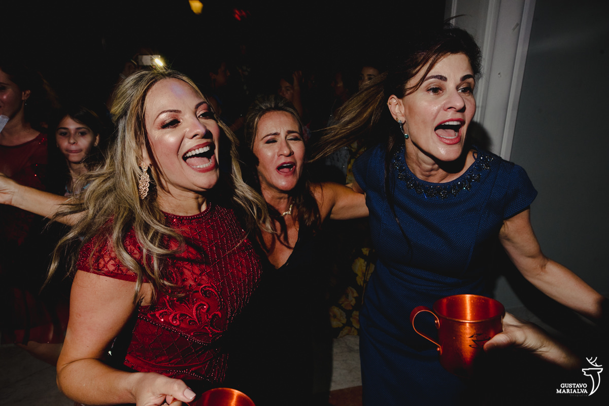 mulher usando vestido vinho dança com amigas 