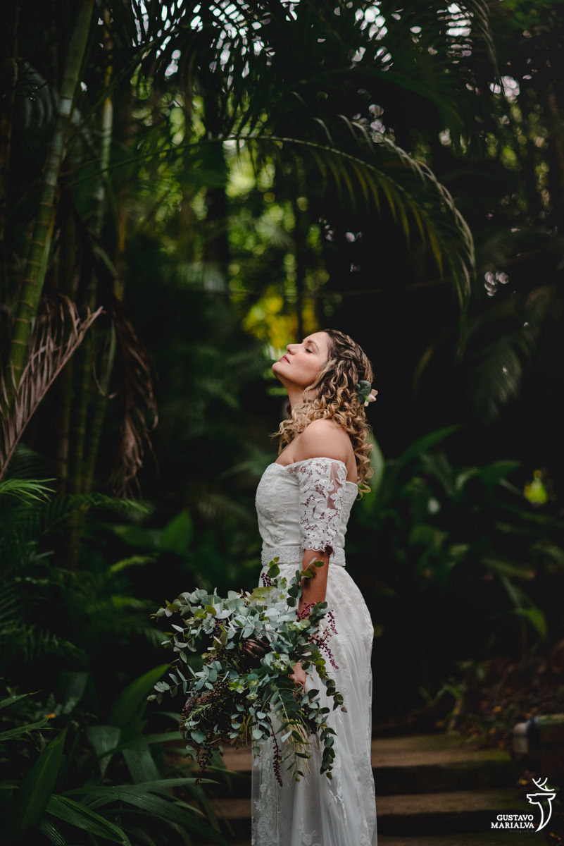 noiva de vestido de noiva segurando buque de flores posa para retrato em meio ao verde do restaurante don pascual em vargem grande, no rio de janeiro