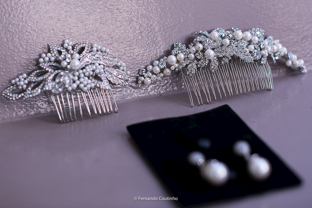 Detalhe dos acessorios da noiva na fotografia de casamento arranjo de cabelos brincos aliancas e complementos para a noiva