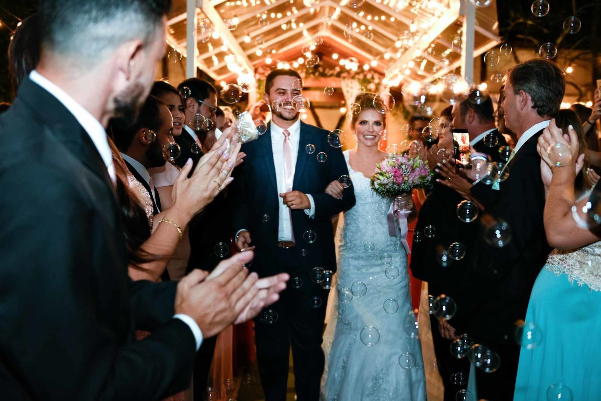 final de celebração e saída alegre do agora casal com bolhas de sabão
