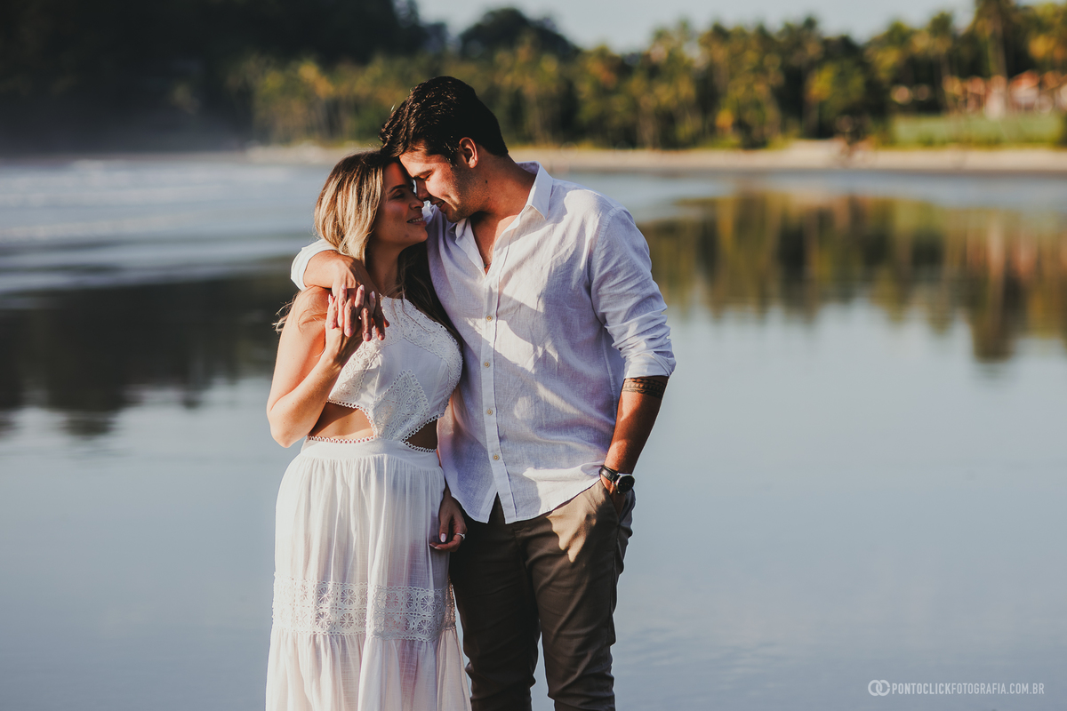 Fotografia de casal realizada no Guarujá com Guilherme e Katioska em ensaio pre wedding romântico na praia, destacando luz dourada, reflexos na areia e clima leve próximo ao mar