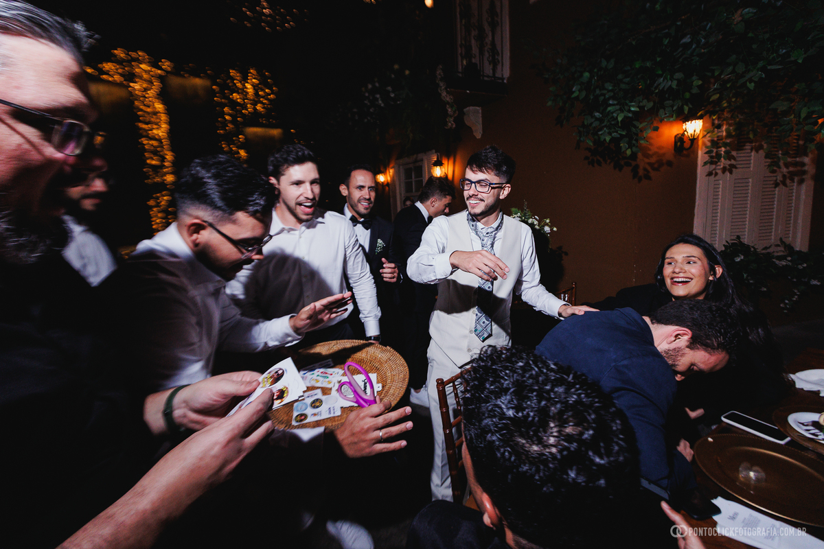 O noivo participa de uma brincadeira com amigos durante a festa de casamento, encerrando a celebração com muita descontração e alegria. Fotógrafo de casamento Pontoclick Fotografia.