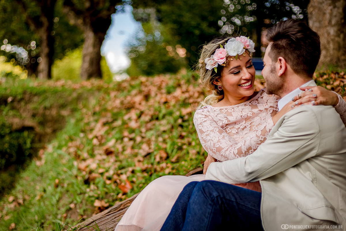 noivos sentados na escada e sorrindo um para o outro em campos do jordao
