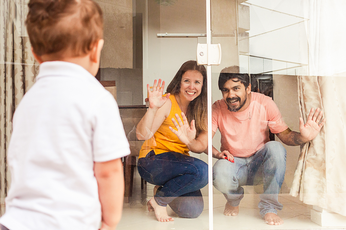 foto de pai e mãe olhando para o filho com sorriso no rosto no ensaio lifestyle de família realizado pela fotografa karina castro