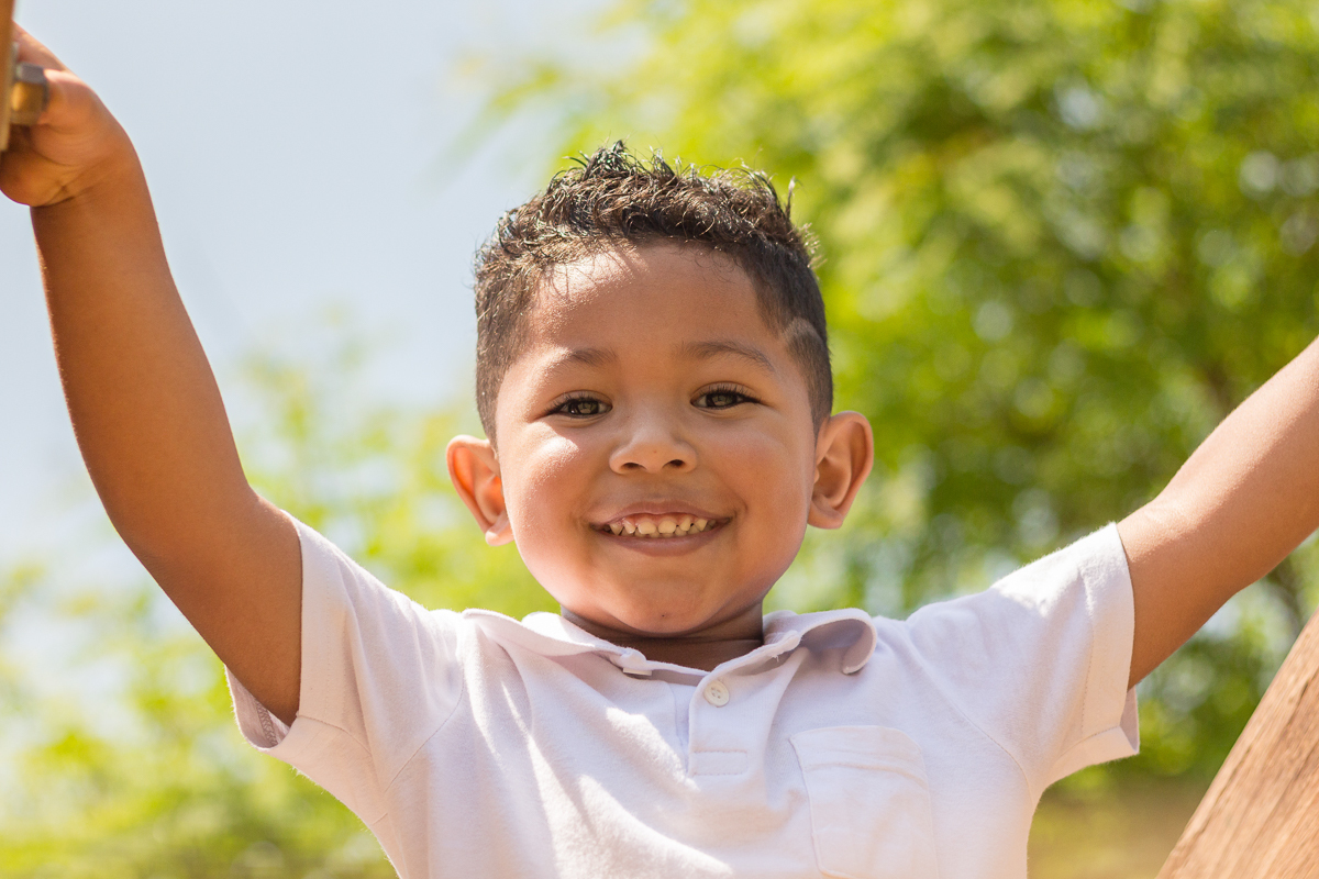 foto de menino sorrindo no ensaio infantil e brincando no Parque do Ibirapuera na cidade de São Paulo