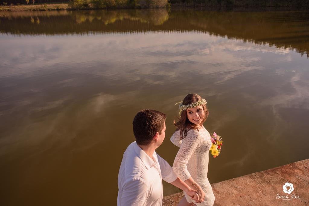 Casal de noivos, Daniele e Thiago, correndo de mãos dadas no lago em Dourados - MS, Sinhá Flor Fotografia