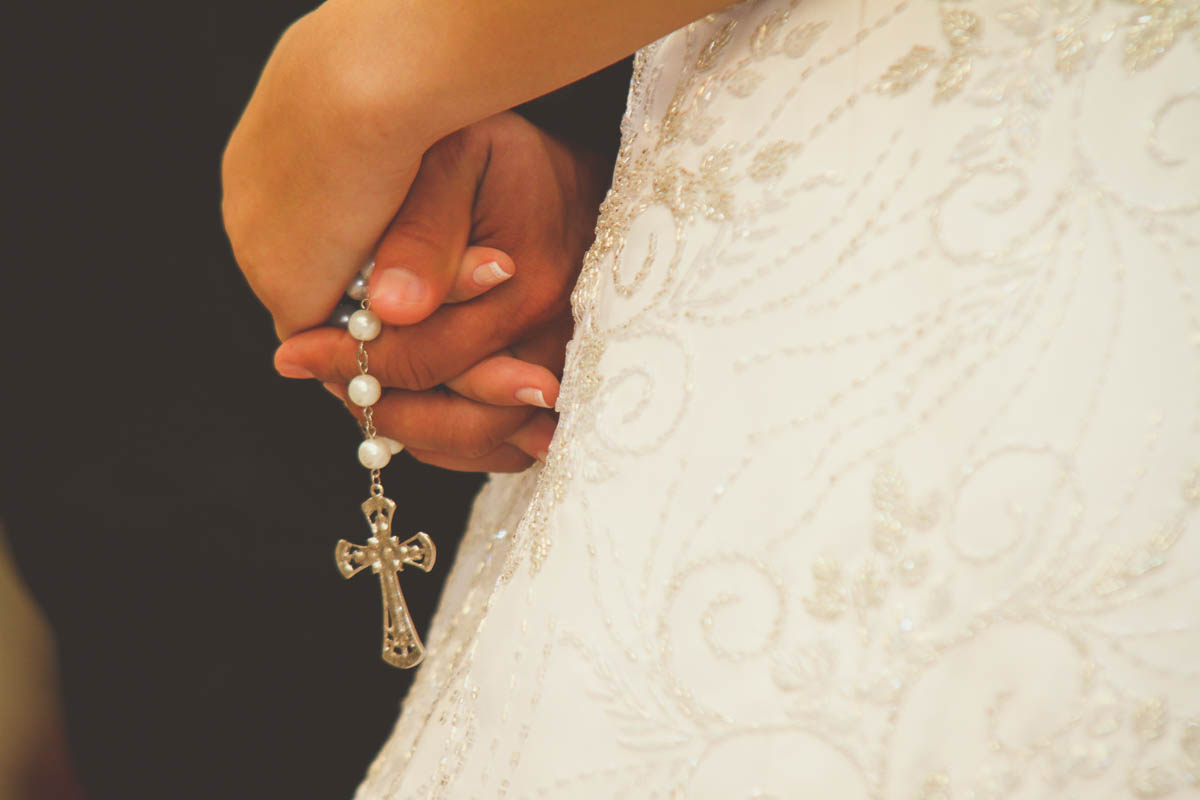 Detalhe do vestido da noiva e terço