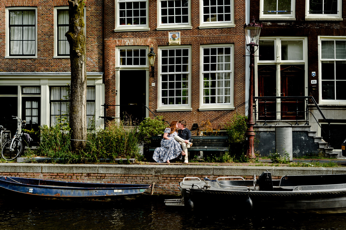 Jordaan houses with bikes and flowers. Couple's summer holiday in Amsterdam