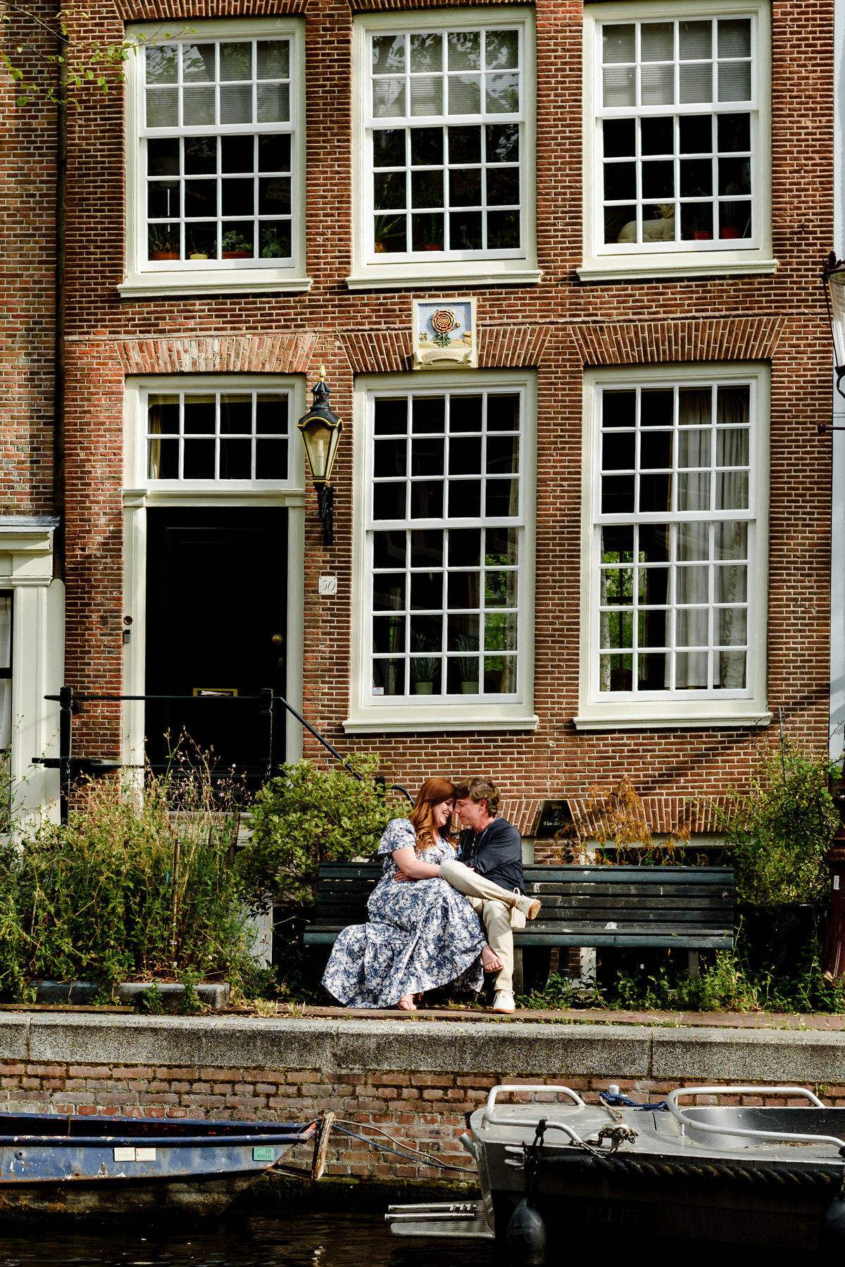Jordaan houses with bikes and flowers. Couple's summer holiday in Amsterdam
