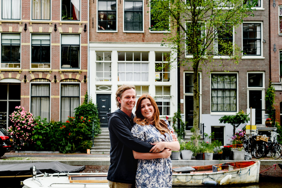 Jordaan houses with bikes and flowers. Couple's summer holiday in Amsterdam