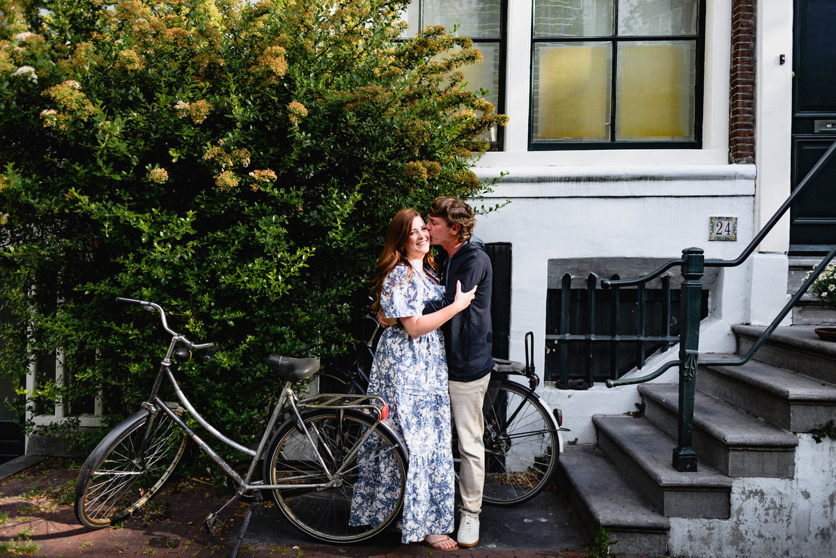 Jordaan houses with bikes and flowers. Couple's summer holiday in Amsterdam