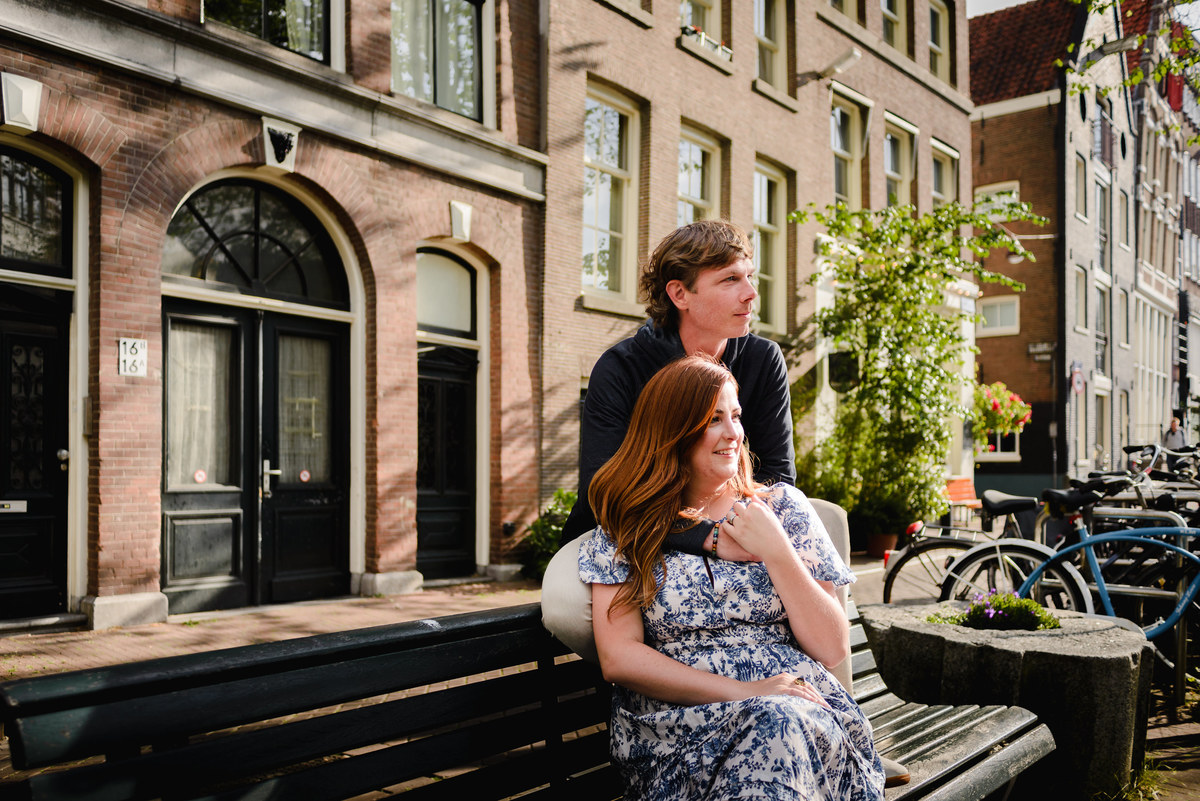 Jordaan houses with bikes and flowers. Couple's summer holiday in Amsterdam
