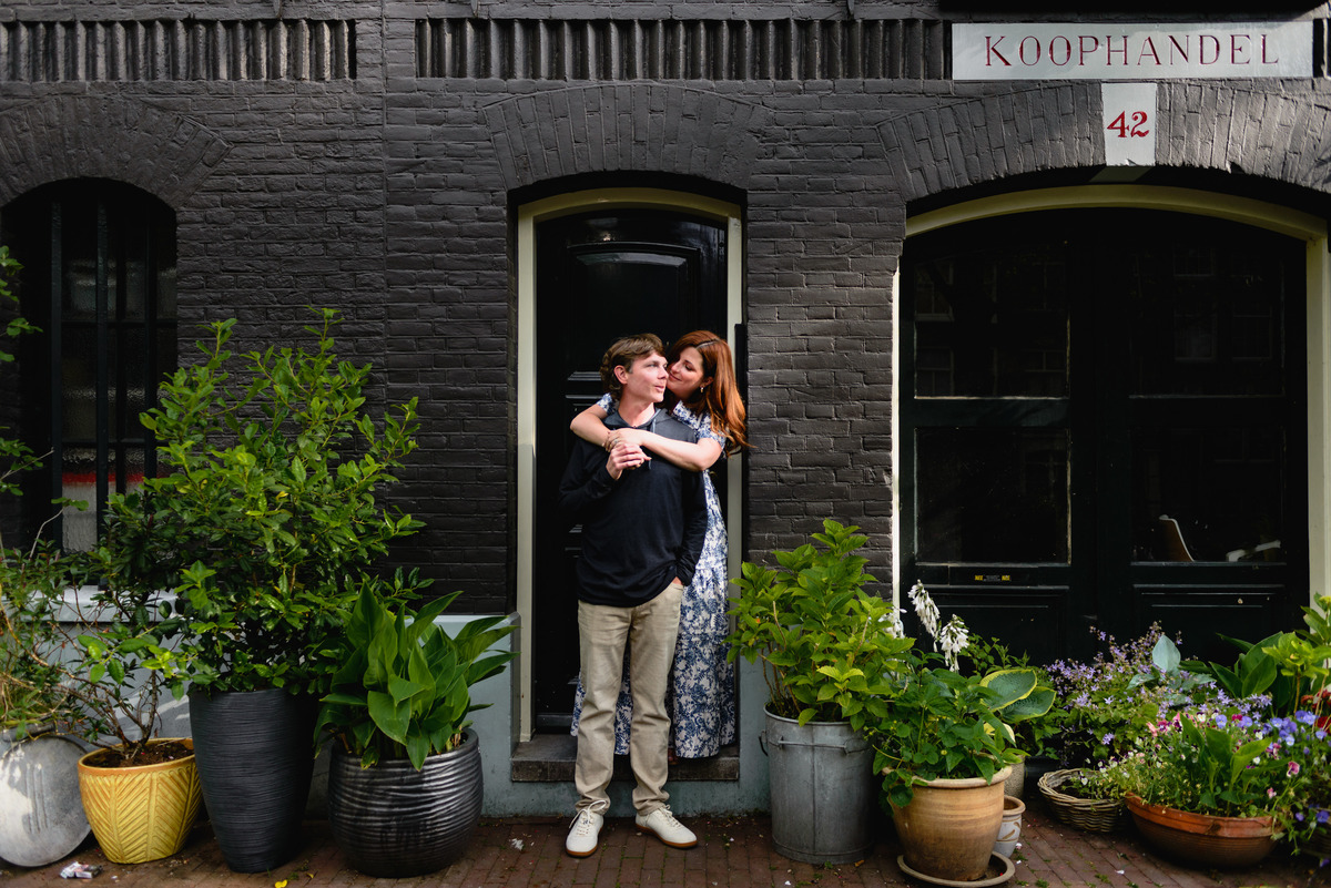 Jordaan houses with bikes and flowers. Couple's summer holiday in Amsterdam