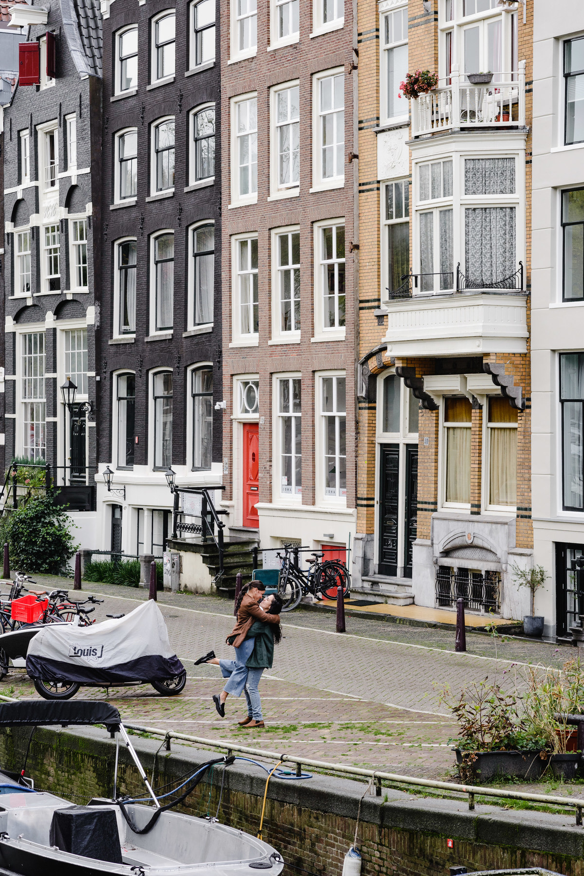 same sex couple in front of an Amsterdam house