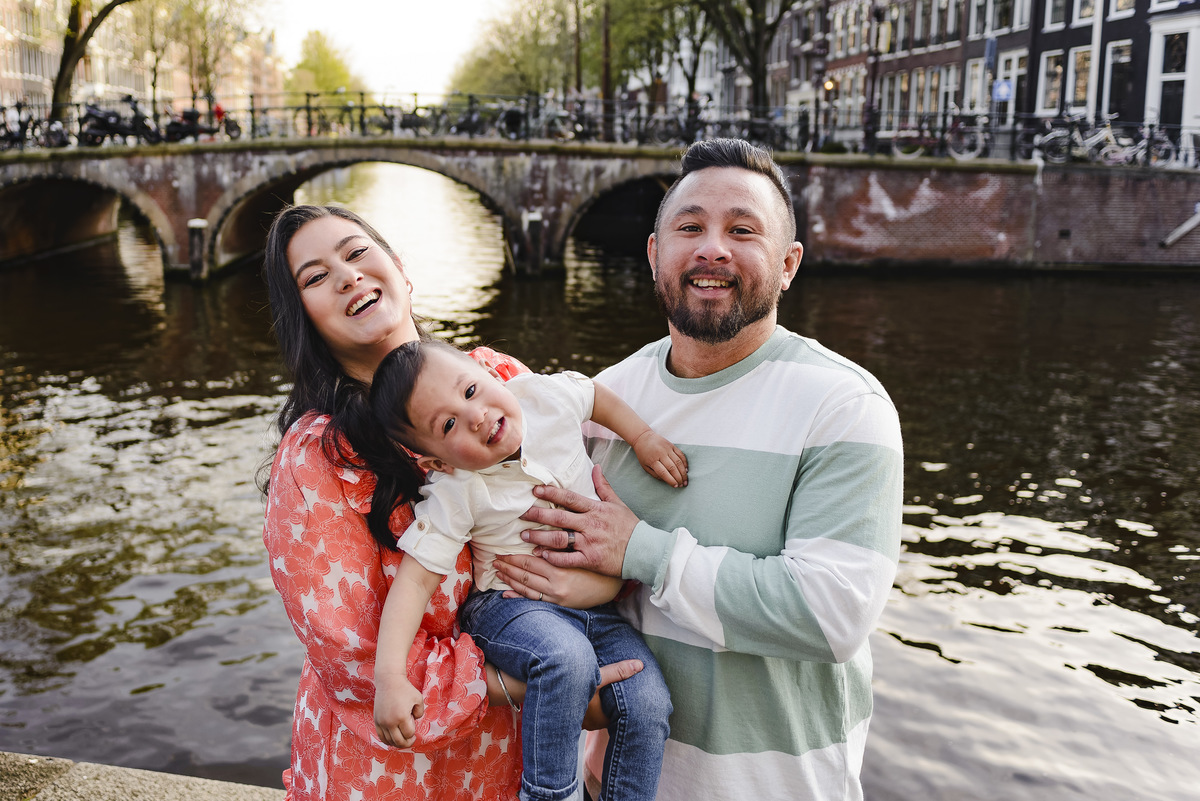 Family trip in Amsterdam, The Netherlands. Photo session in Amsterdam streets, canals and architecture of the jordaan area