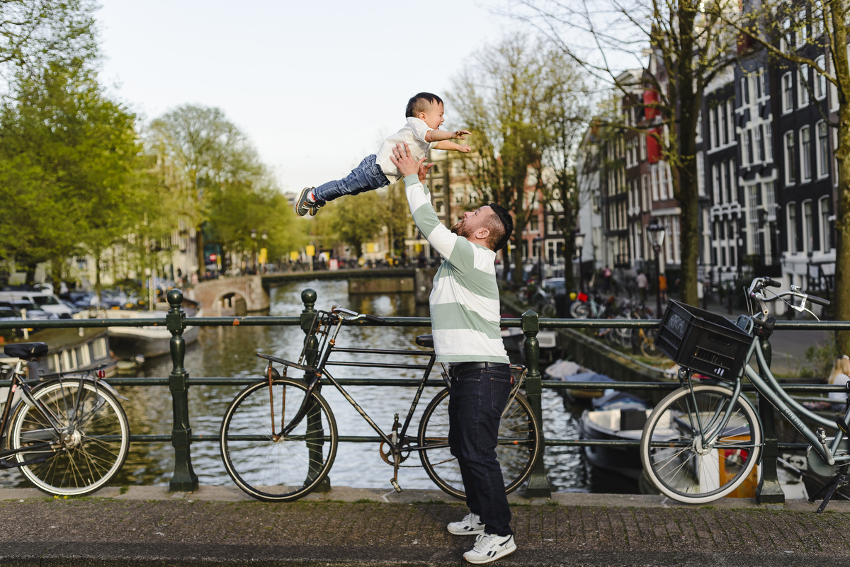 Family trip in Amsterdam, The Netherlands. Photo session in Amsterdam streets, canals and architecture of the jordaan area