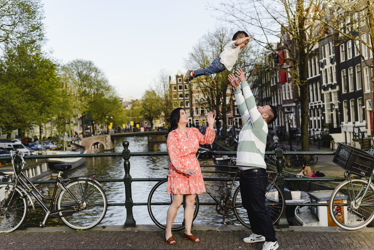 Family trip in Amsterdam, The Netherlands. Photo session in Amsterdam streets, canals and architecture of the jordaan area