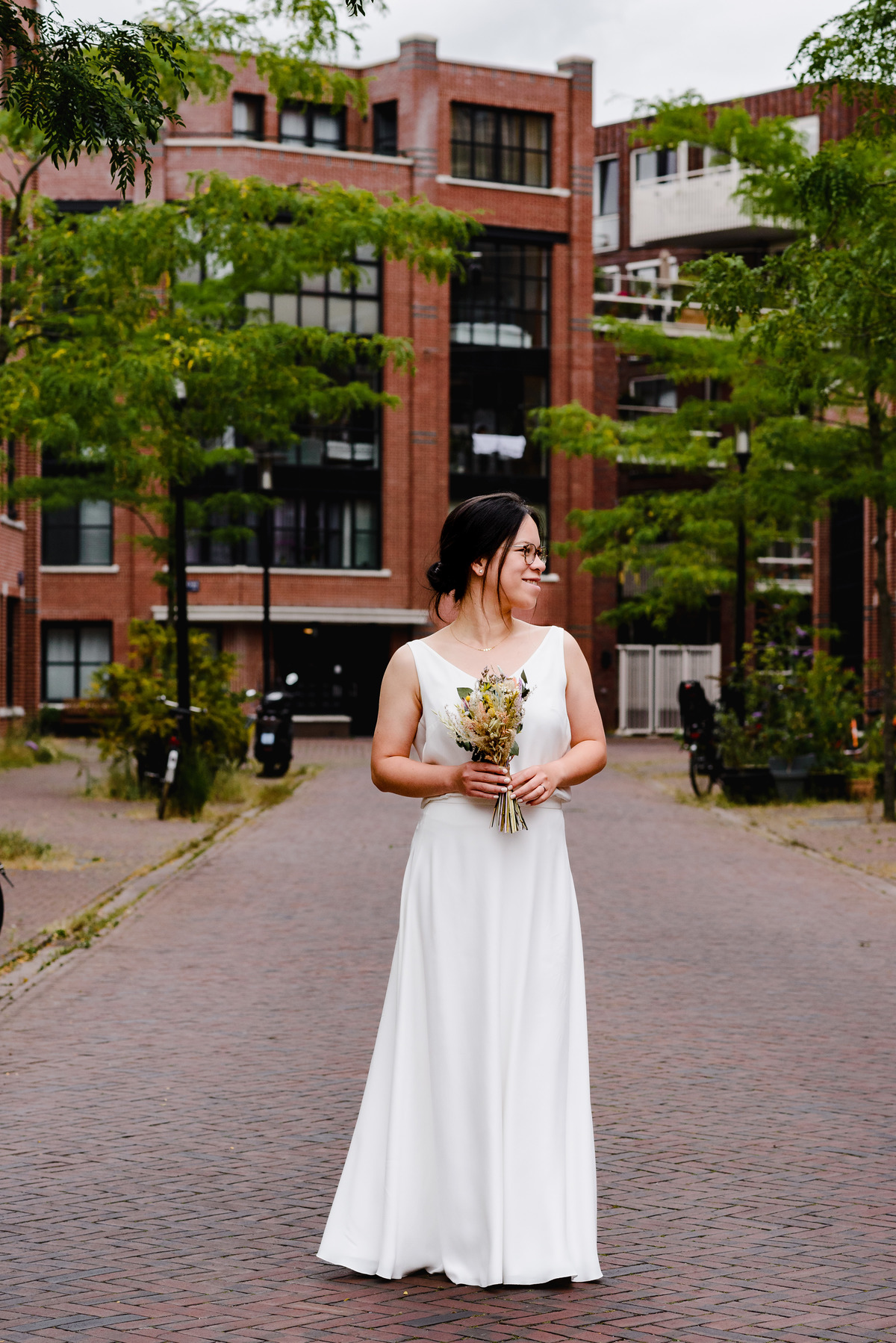 Wedding photographer in Amsterdam photographing a couple in love at gemeente Stadsloket Oost. The bride.