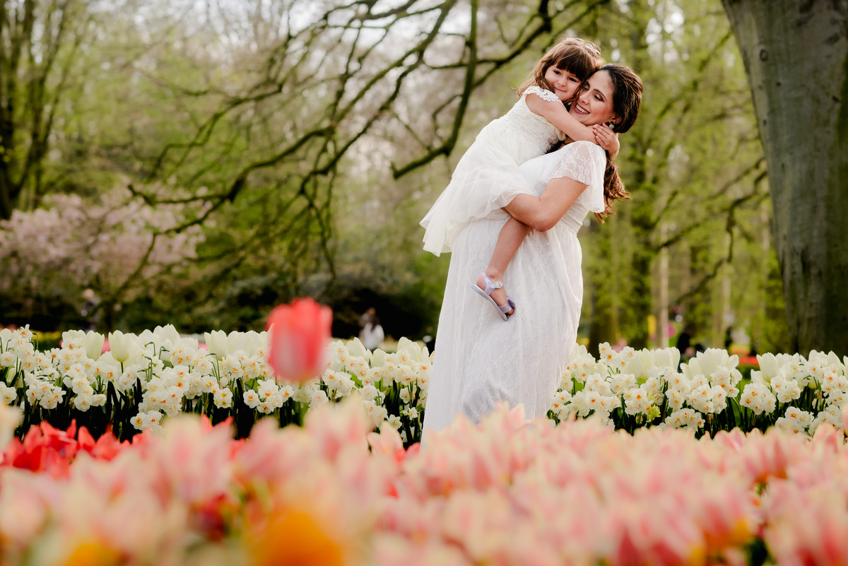 Maternity photo session at Keukenhof Gardens on a Sunday afternoon in April. Vacation photographer and local expert capturing stunning moments in tulip fields near Amsterdam, Netherlands
