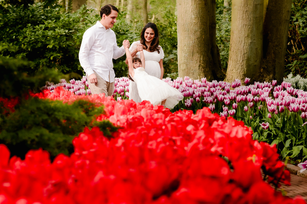 Maternity photo session at Keukenhof Gardens on a Sunday afternoon in April. Vacation photographer and local expert capturing stunning moments in tulip fields near Amsterdam, Netherlands
