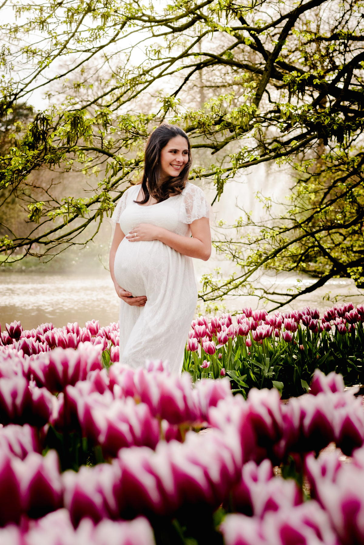 Maternity photo session at Keukenhof Gardens on a Sunday afternoon in April. Vacation photographer and local expert capturing stunning moments in tulip fields near Amsterdam, Netherlands