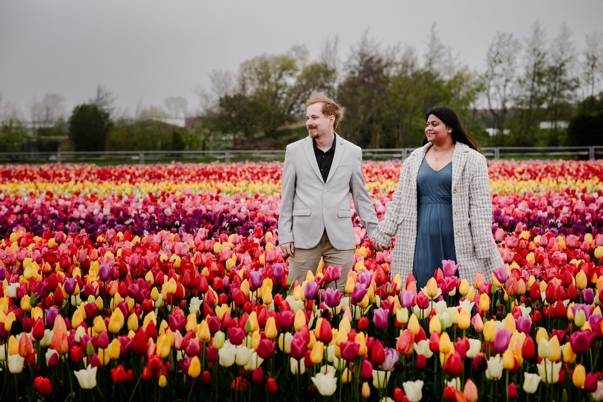 Tanya and Logan’s engagement photoshoot in the Netherlands' tulip fields started with a bike ride from Hillegom station. Despite the cold weather, we captured beautiful moments at The Tulip Barn, showcasing their love in stunning surroundings.