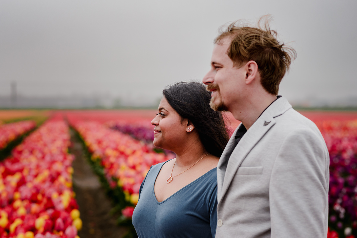 Tanya and Logan’s engagement photoshoot in the Netherlands' tulip fields started with a bike ride from Hillegom station. Despite the cold weather, we captured beautiful moments at The Tulip Barn, showcasing their love in stunning surroundings.