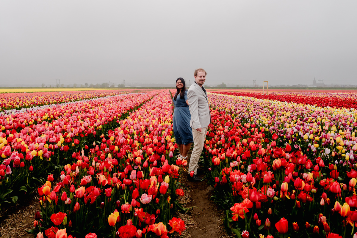 Tanya and Logan’s engagement photoshoot in the Netherlands' tulip fields started with a bike ride from Hillegom station. Despite the cold weather, we captured beautiful moments at The Tulip Barn, showcasing their love in stunning surroundings.